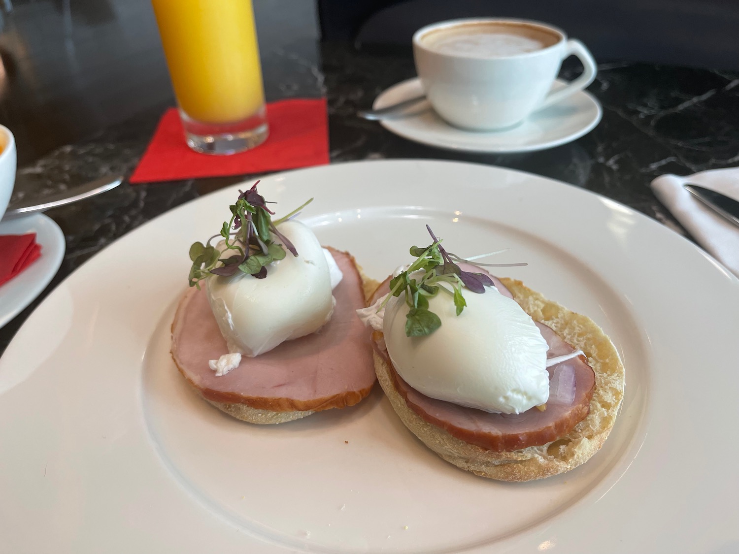 food on a plate next to a cup of coffee