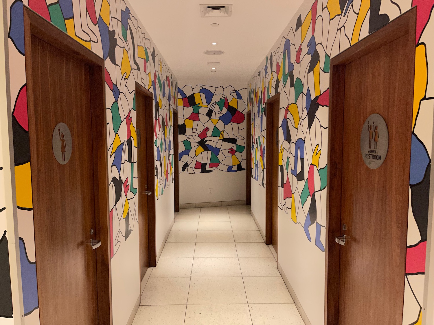 a hallway with doors and colorful wallpaper