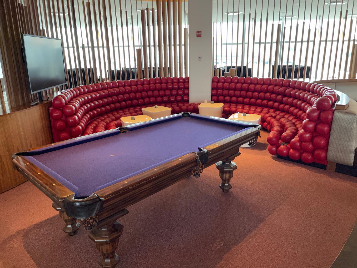 a pool table in a room with red balls