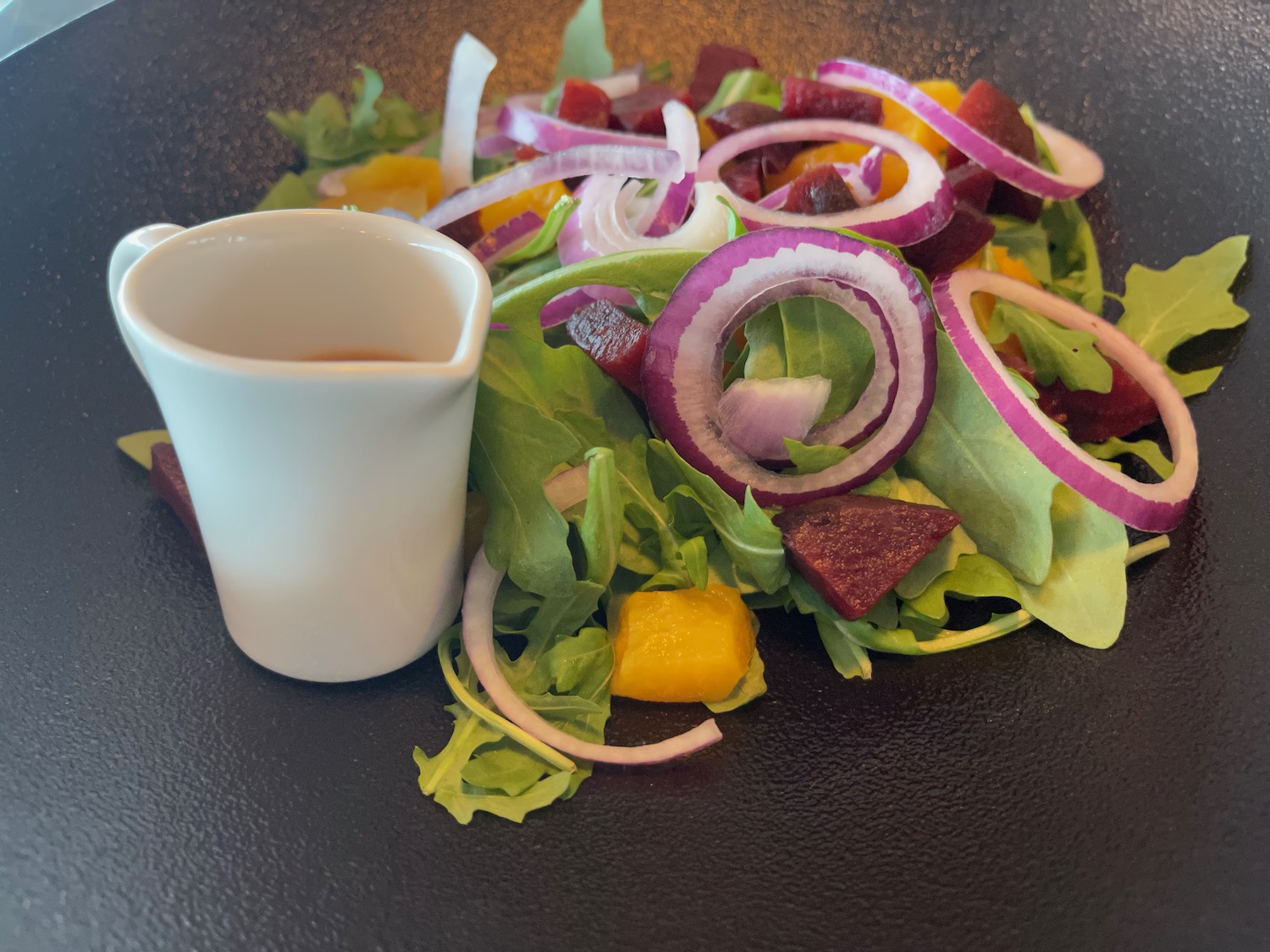 a salad with a sauce in a bowl