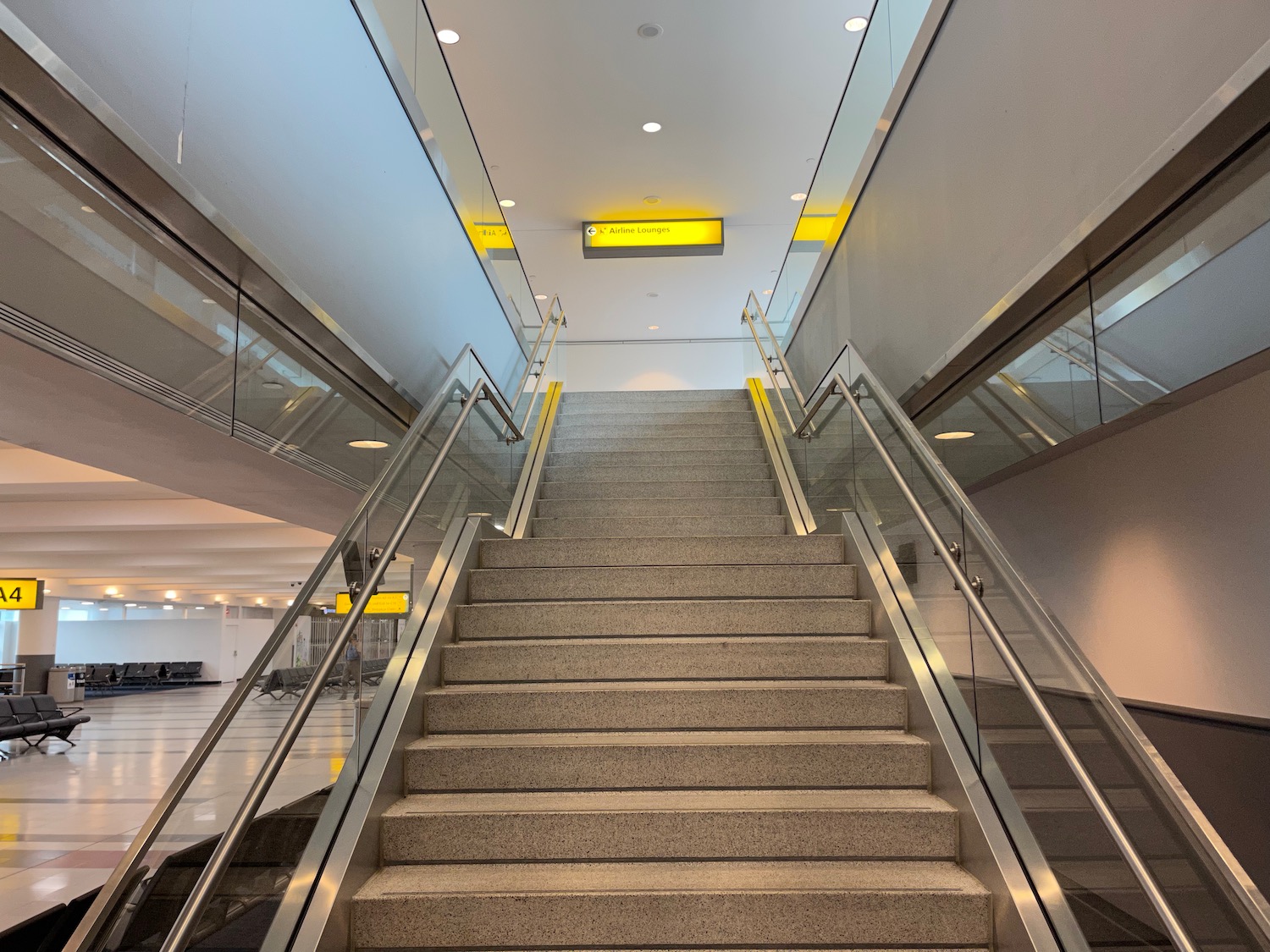 a staircase with metal railings and a yellow sign