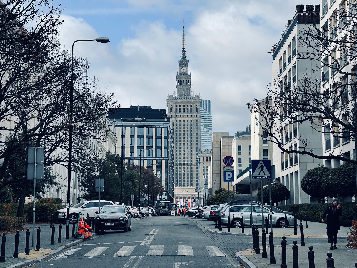 a street with cars and buildings in the background