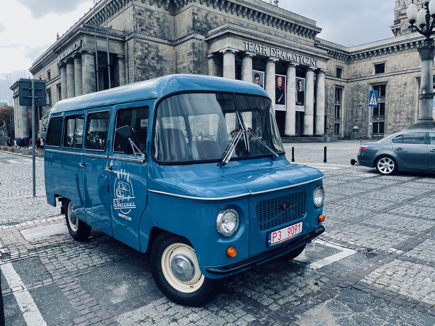 a blue van parked in front of a building