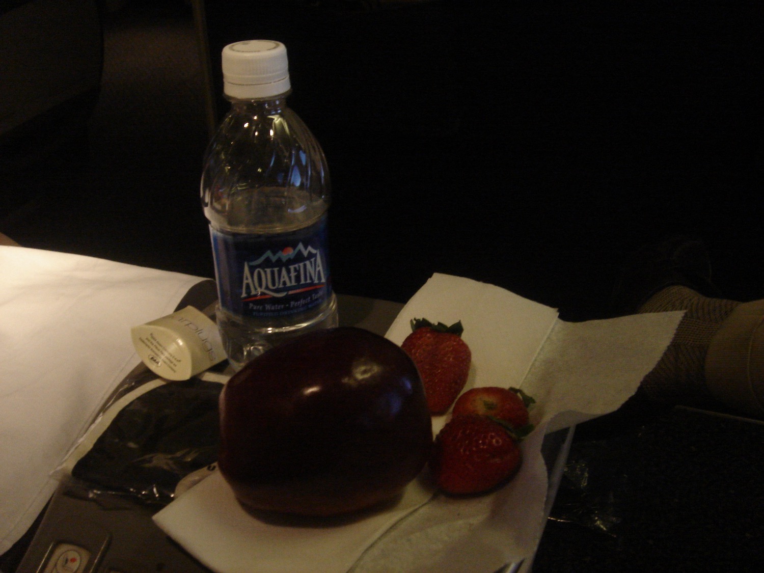 a fruit and a bottle of water on a tray