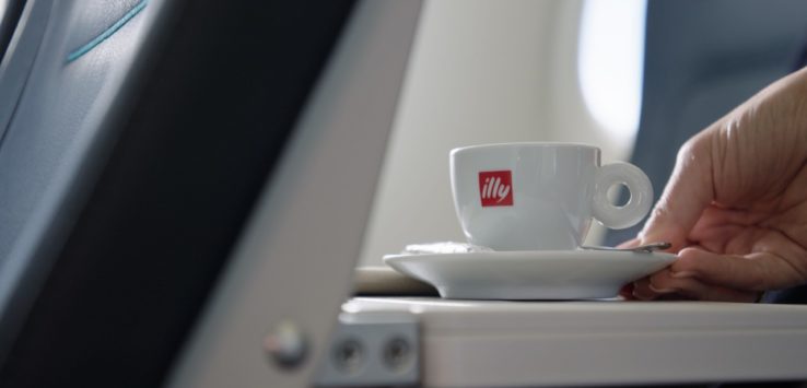 a cup on a saucer on a plane