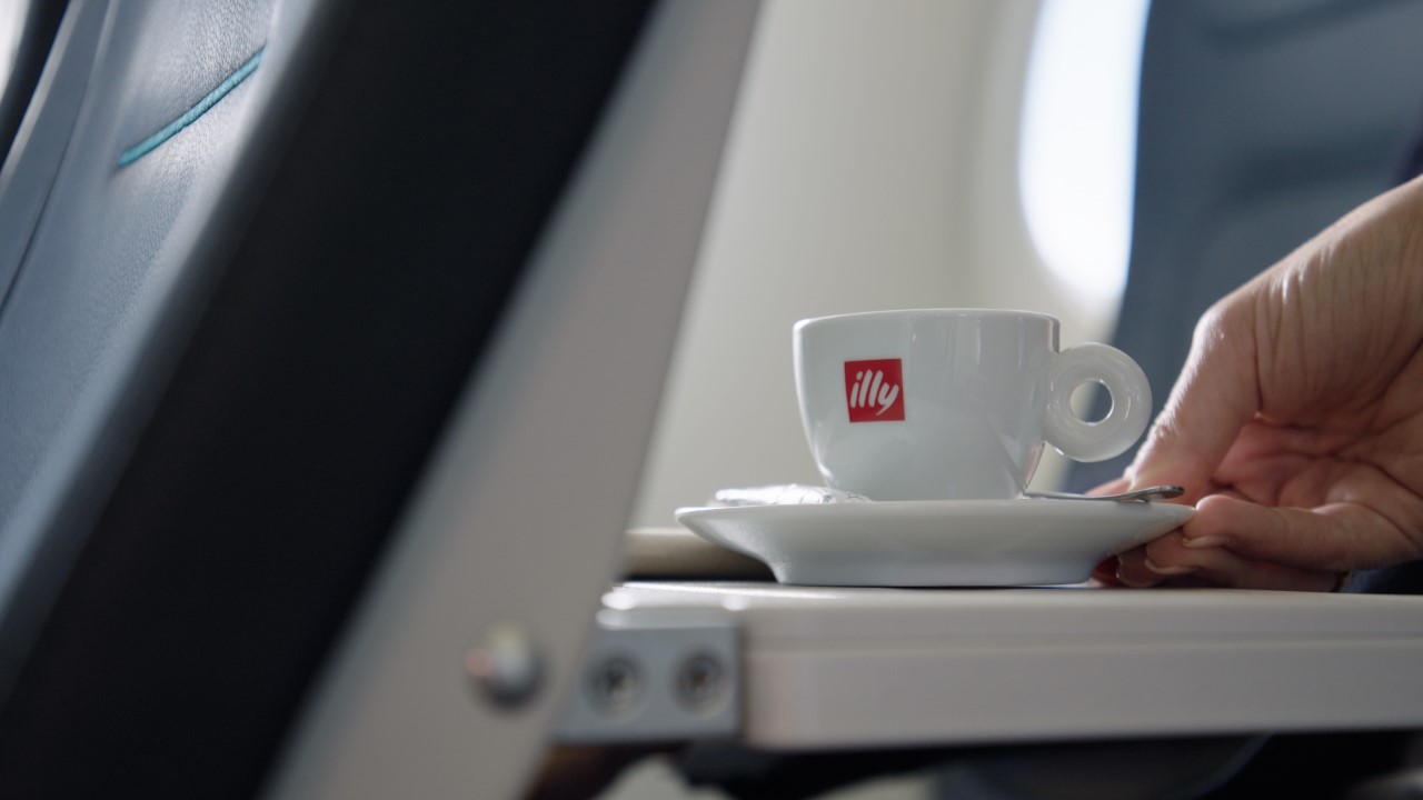 a cup on a saucer on a plane