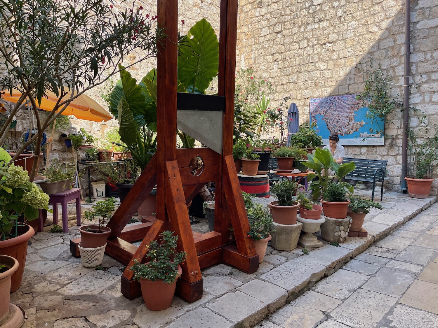 a wooden guillotine with potted plants