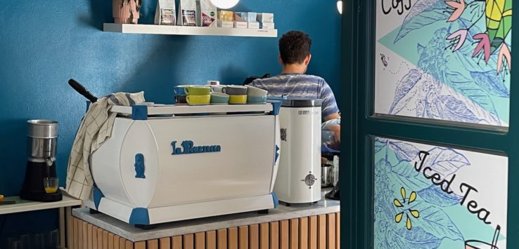 a man behind a counter with a white and blue object