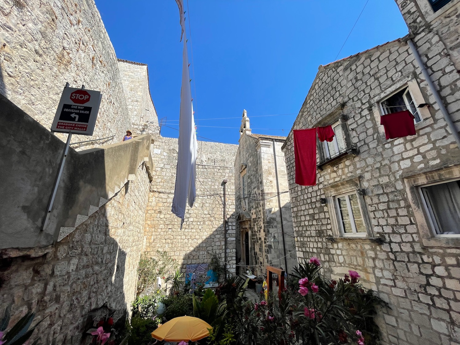 a stone buildings with laundry from the clothesline
