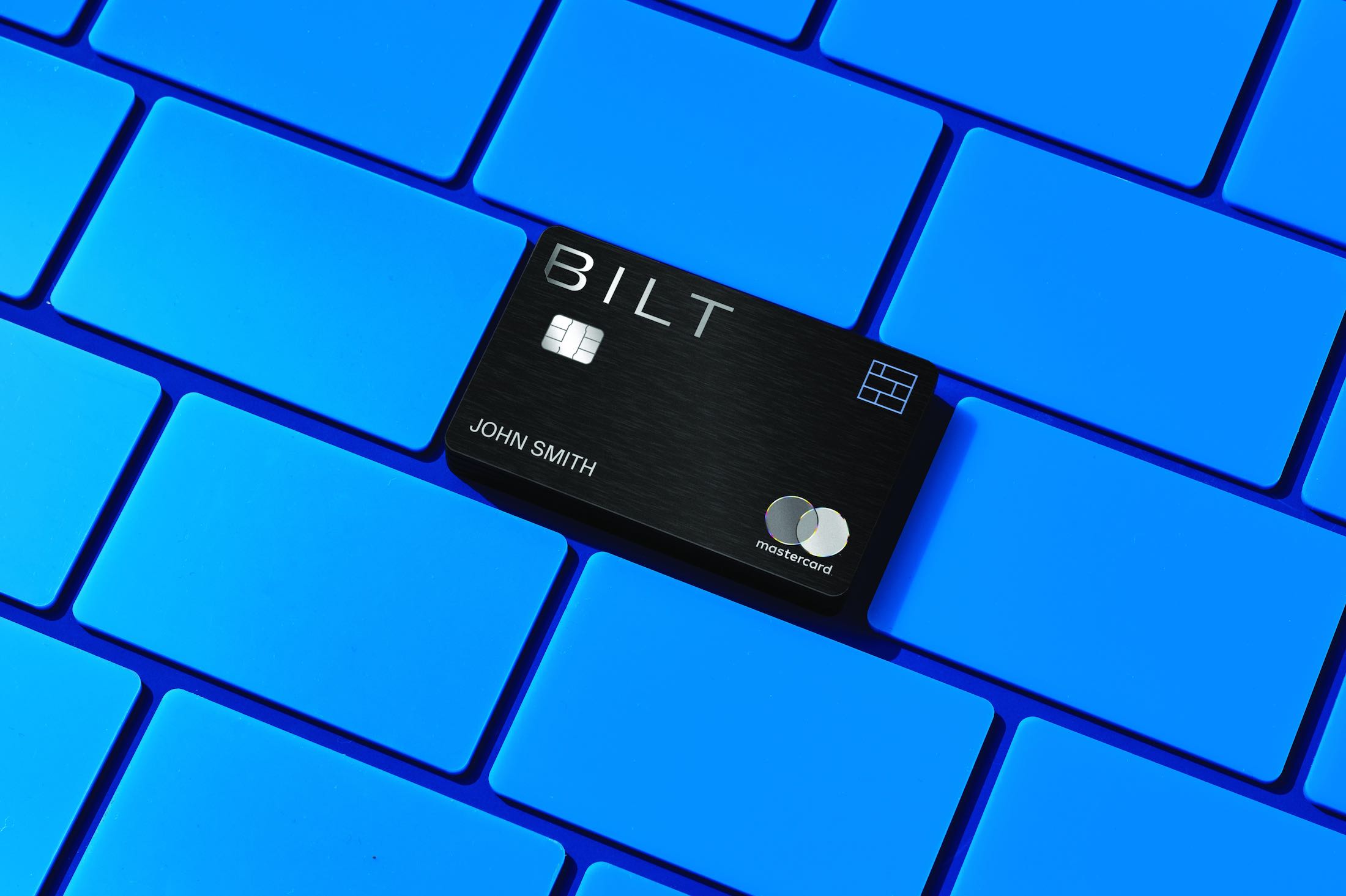 a black credit card on a blue keyboard