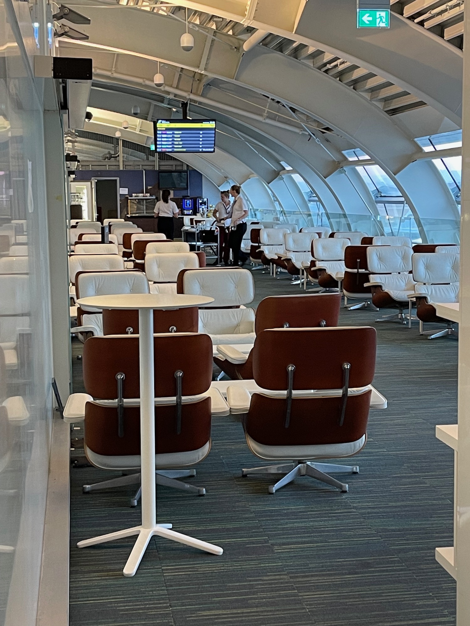 a group of people standing in a room with chairs