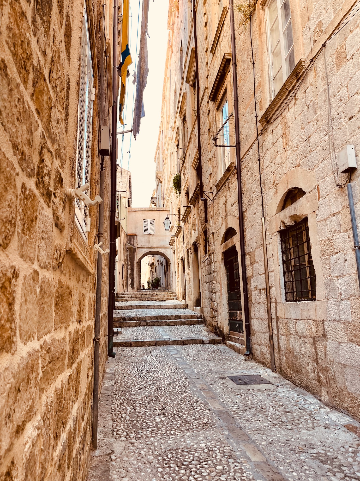 a stone alleyway with stone buildings