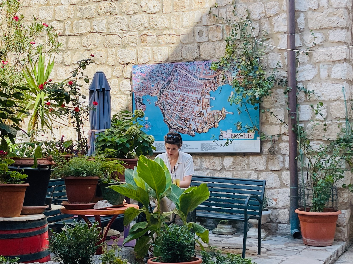 a woman sitting on a bench in front of a map