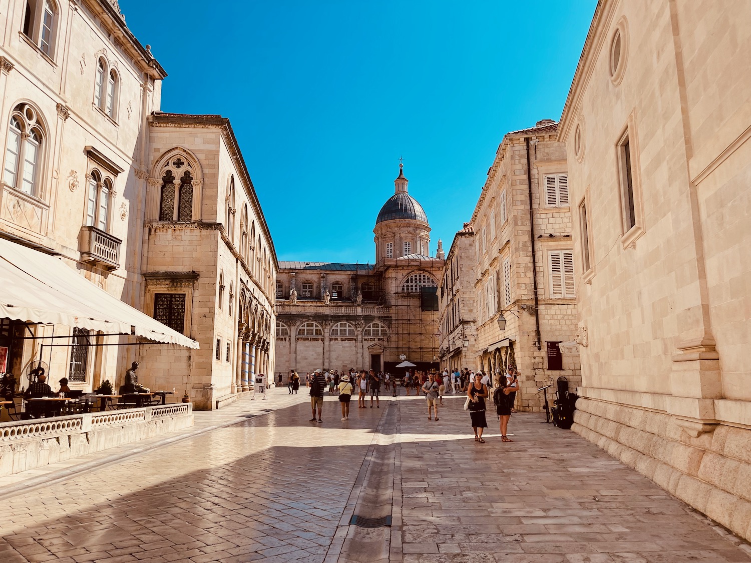 a group of people walking in a courtyard