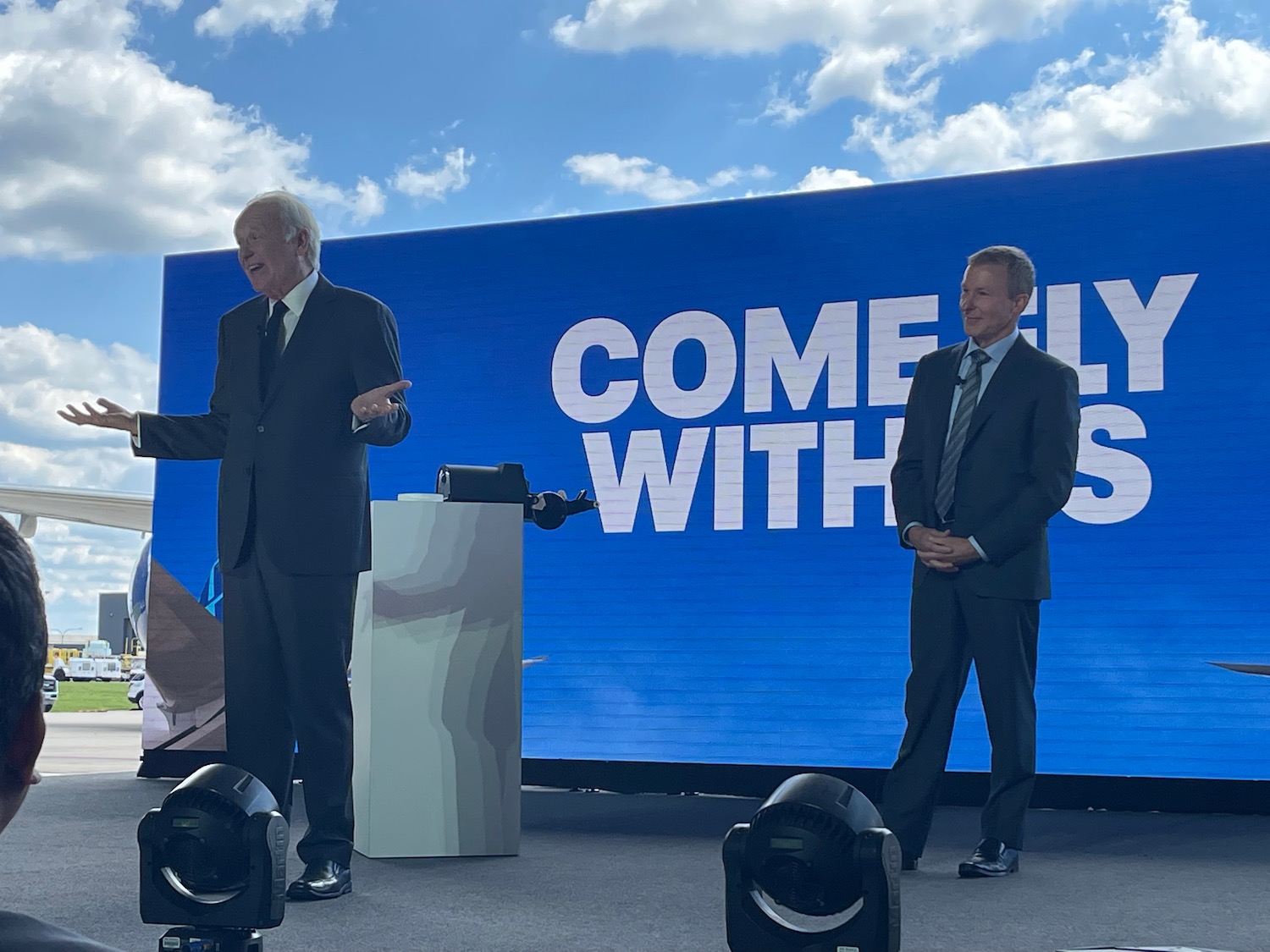 two men standing on a stage