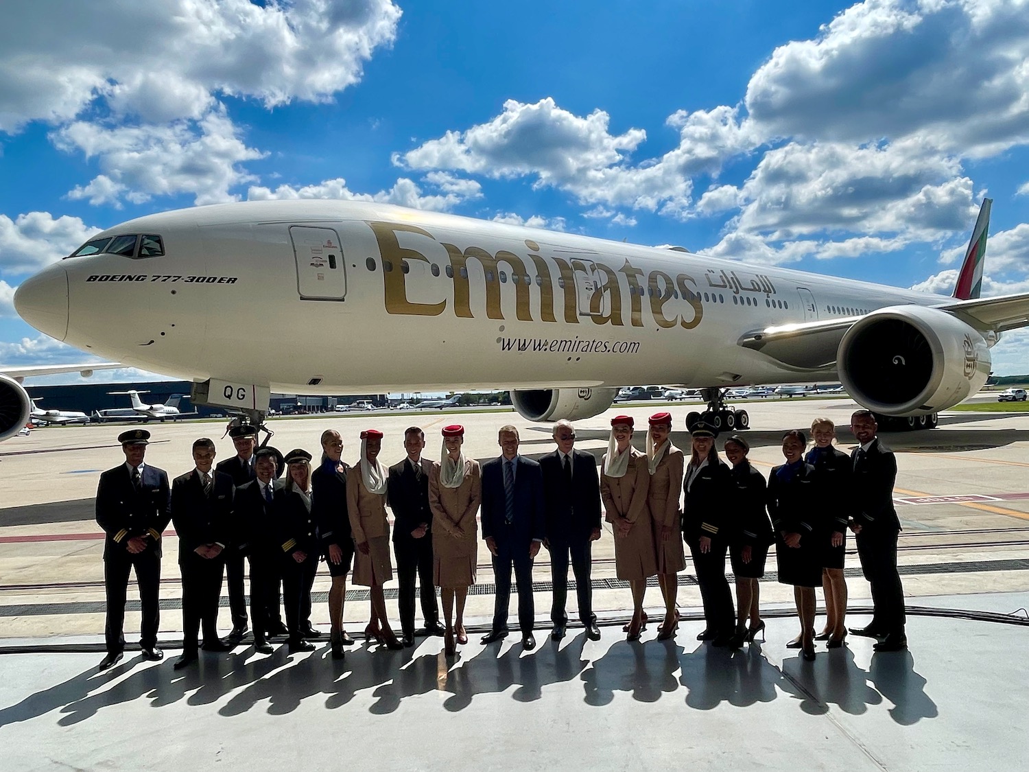 a group of people standing in front of an airplane