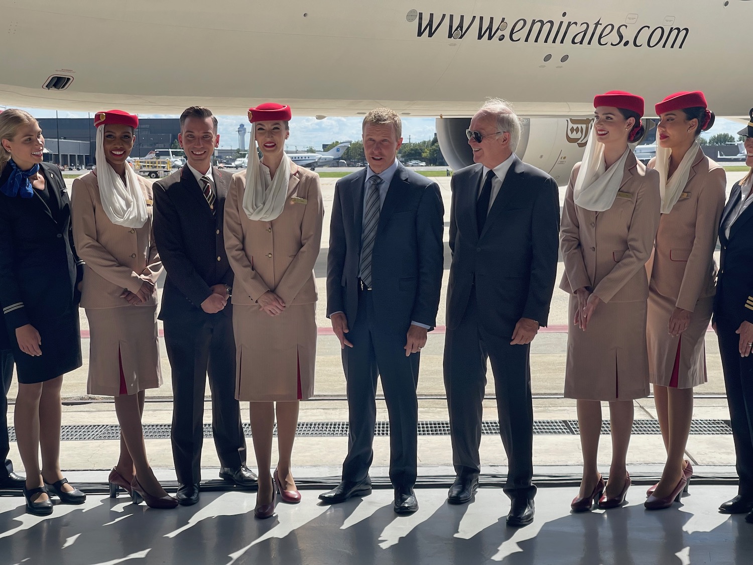 a group of people standing in front of an airplane