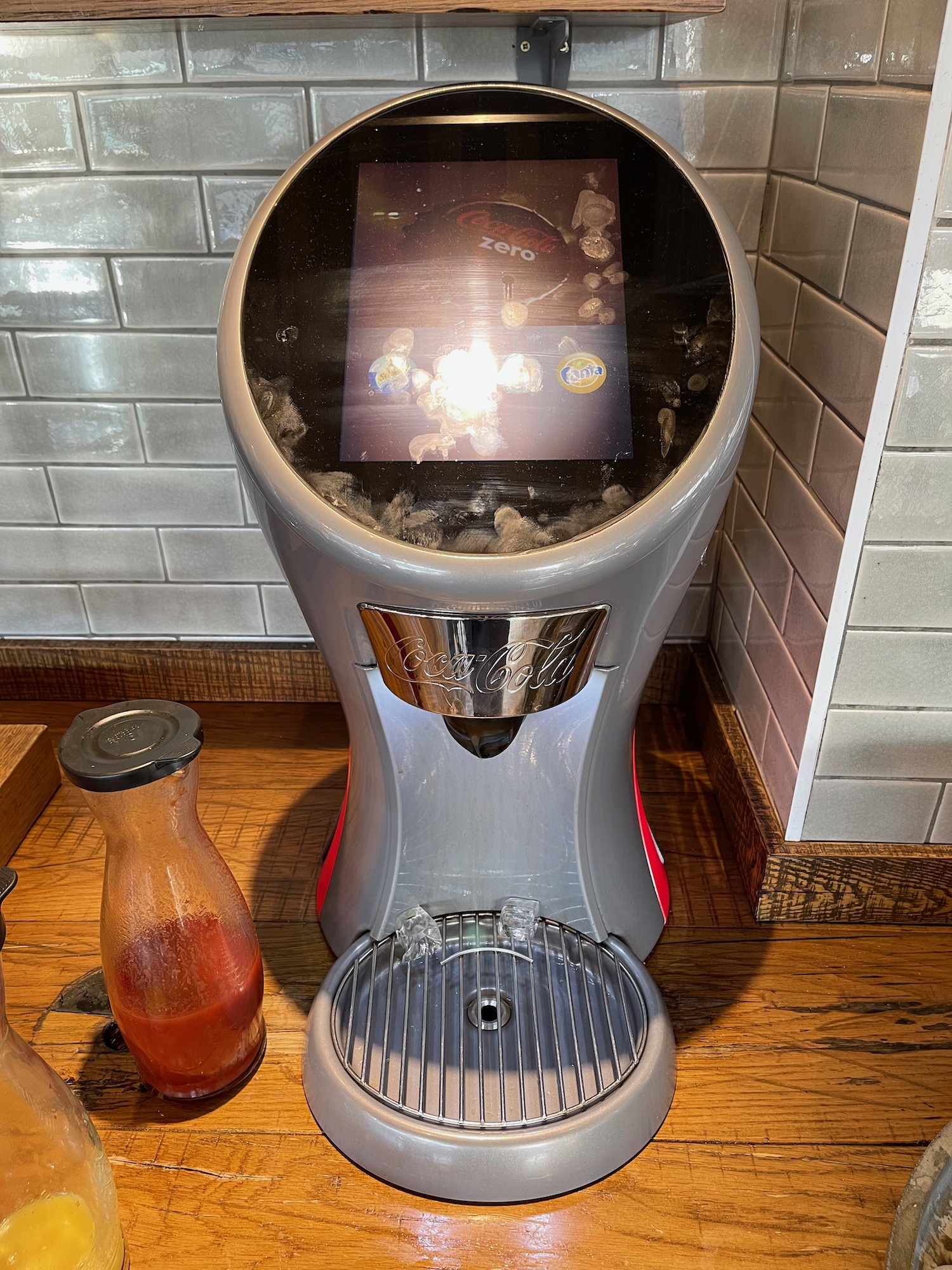 a machine with a screen and a sauce bottle