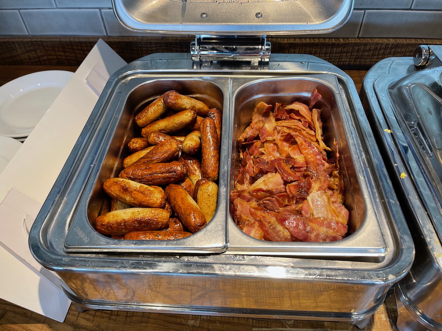 a tray of food with sausages and bacon