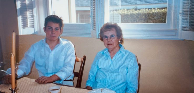 a man and woman sitting at a table with a cake