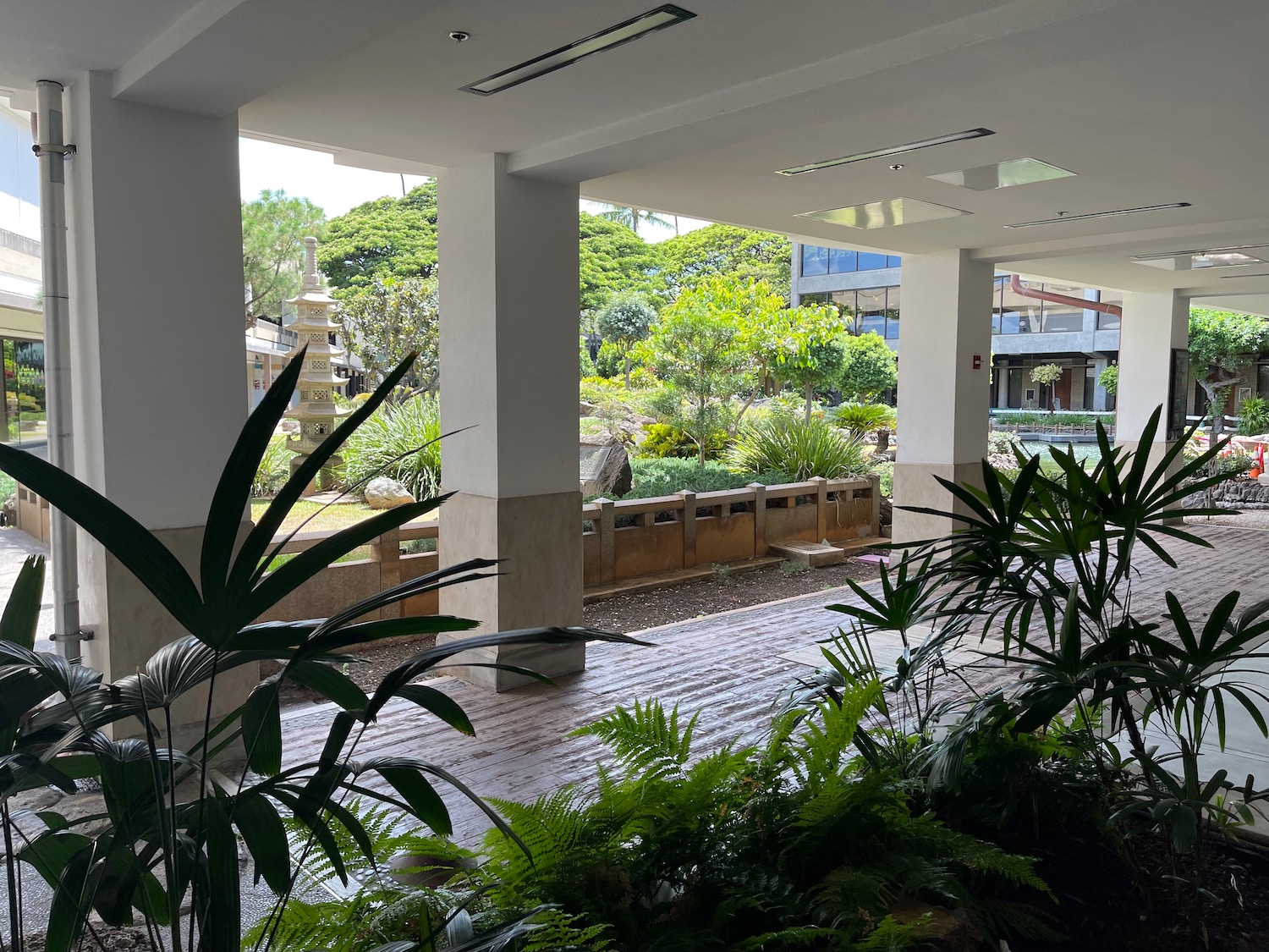 a building with a walkway and plants