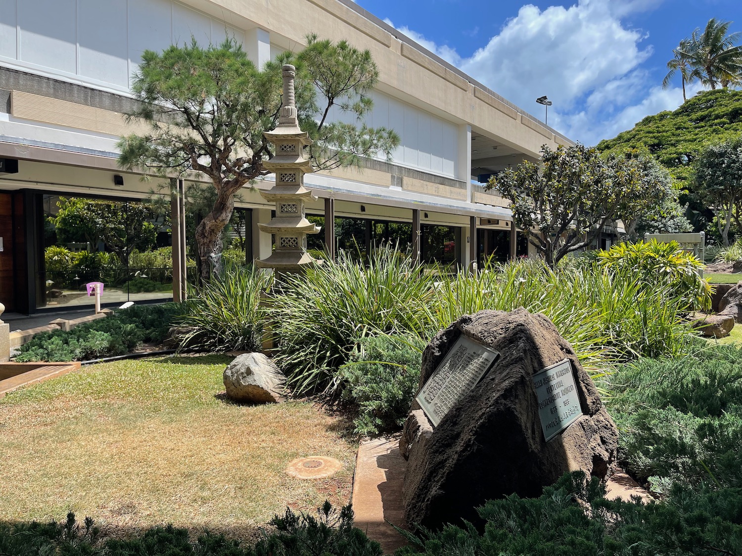 a stone statue in front of a building