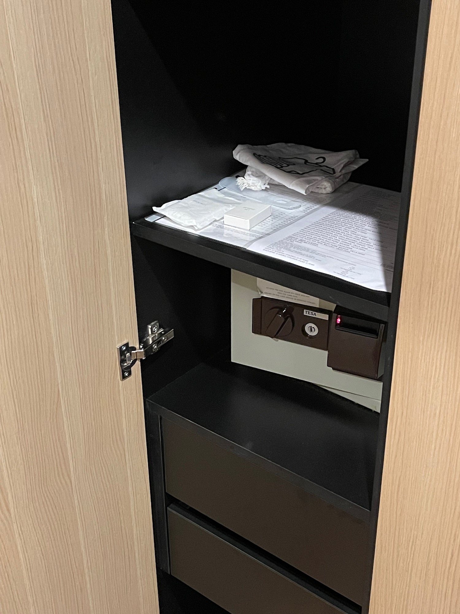 a shelf with papers and a safe