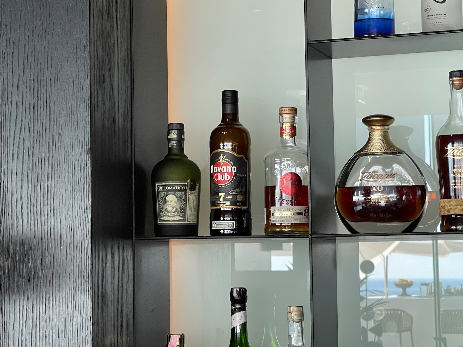 a shelf with bottles of liquor