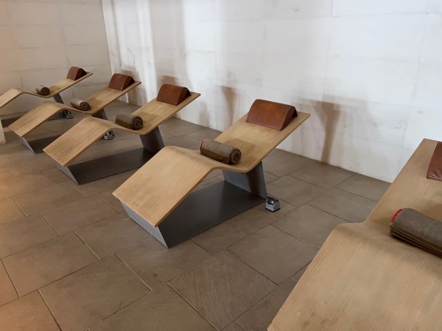 a group of chairs with rolled up mats