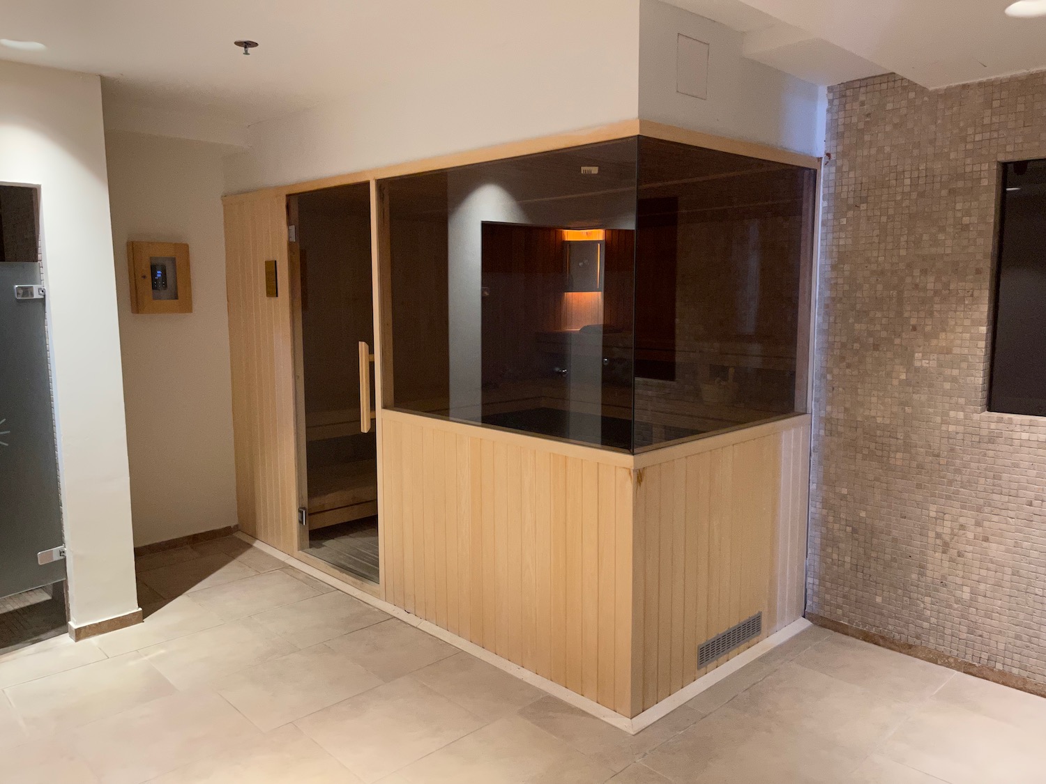 a sauna room with glass doors