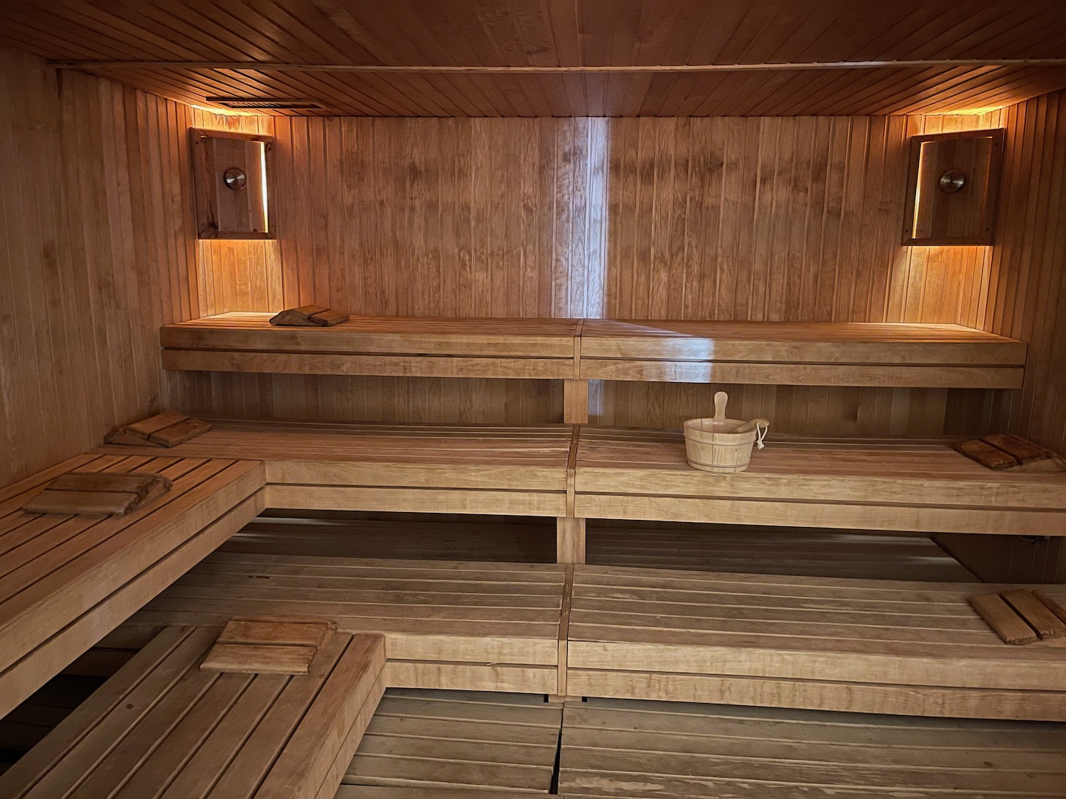 a wooden sauna with a bucket and bucket