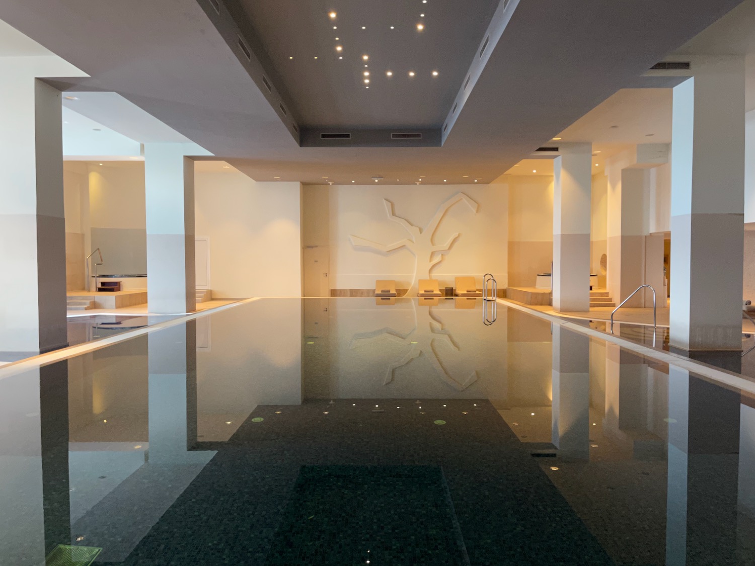 a large indoor pool with a large wall and ceiling