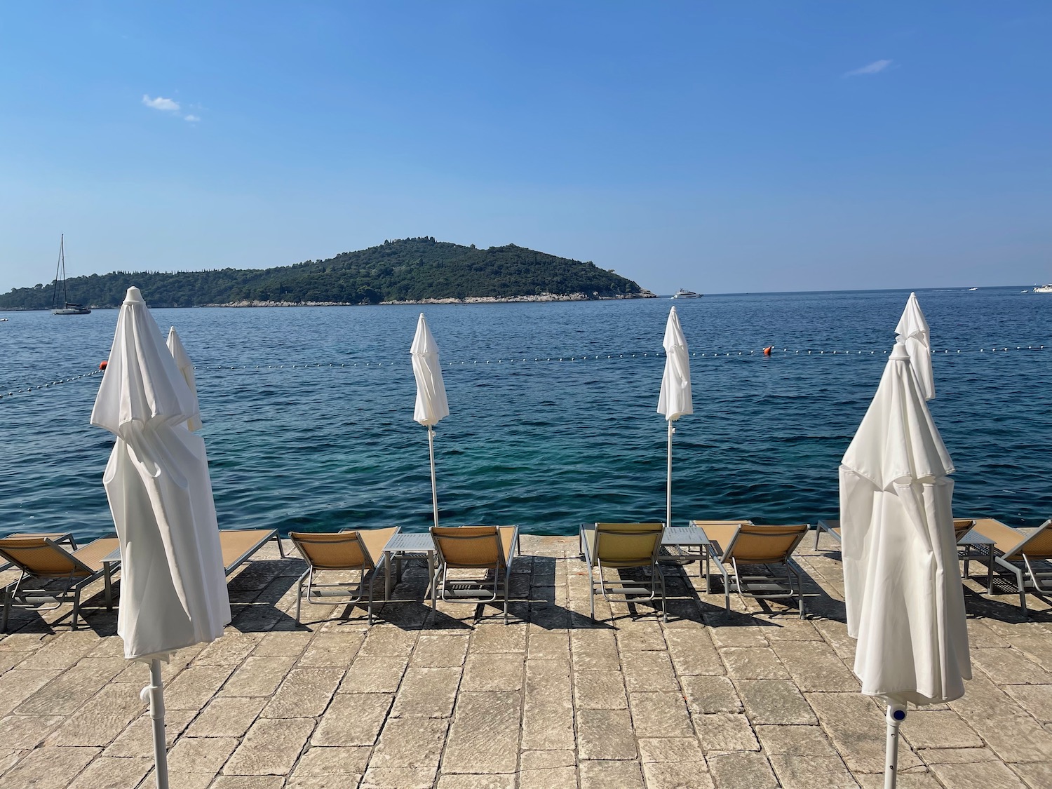 a beach with chairs and umbrellas