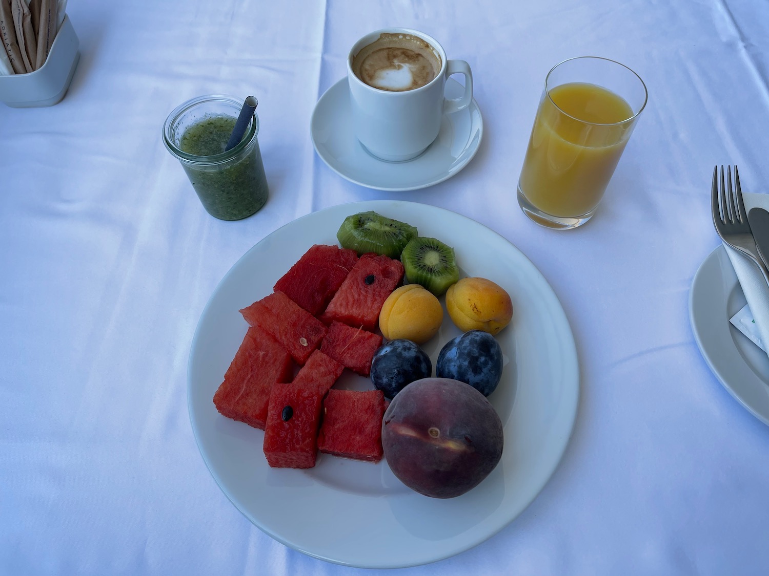 a plate of fruit and a cup of coffee