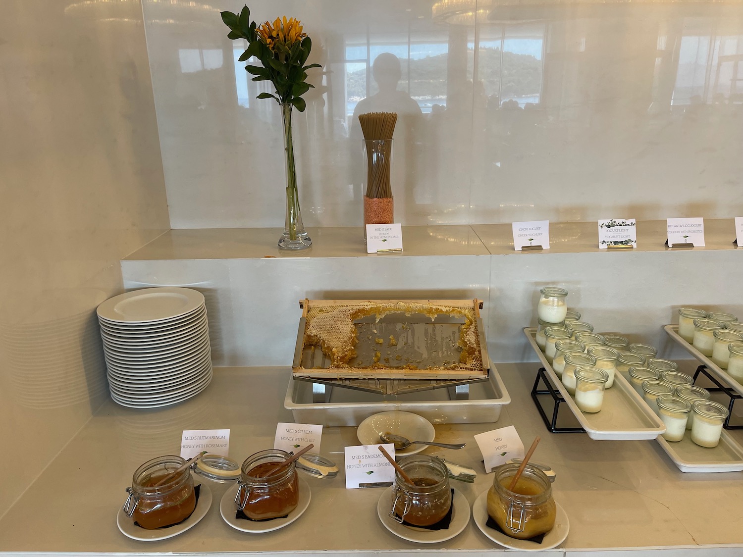 a table with plates and jars of jam