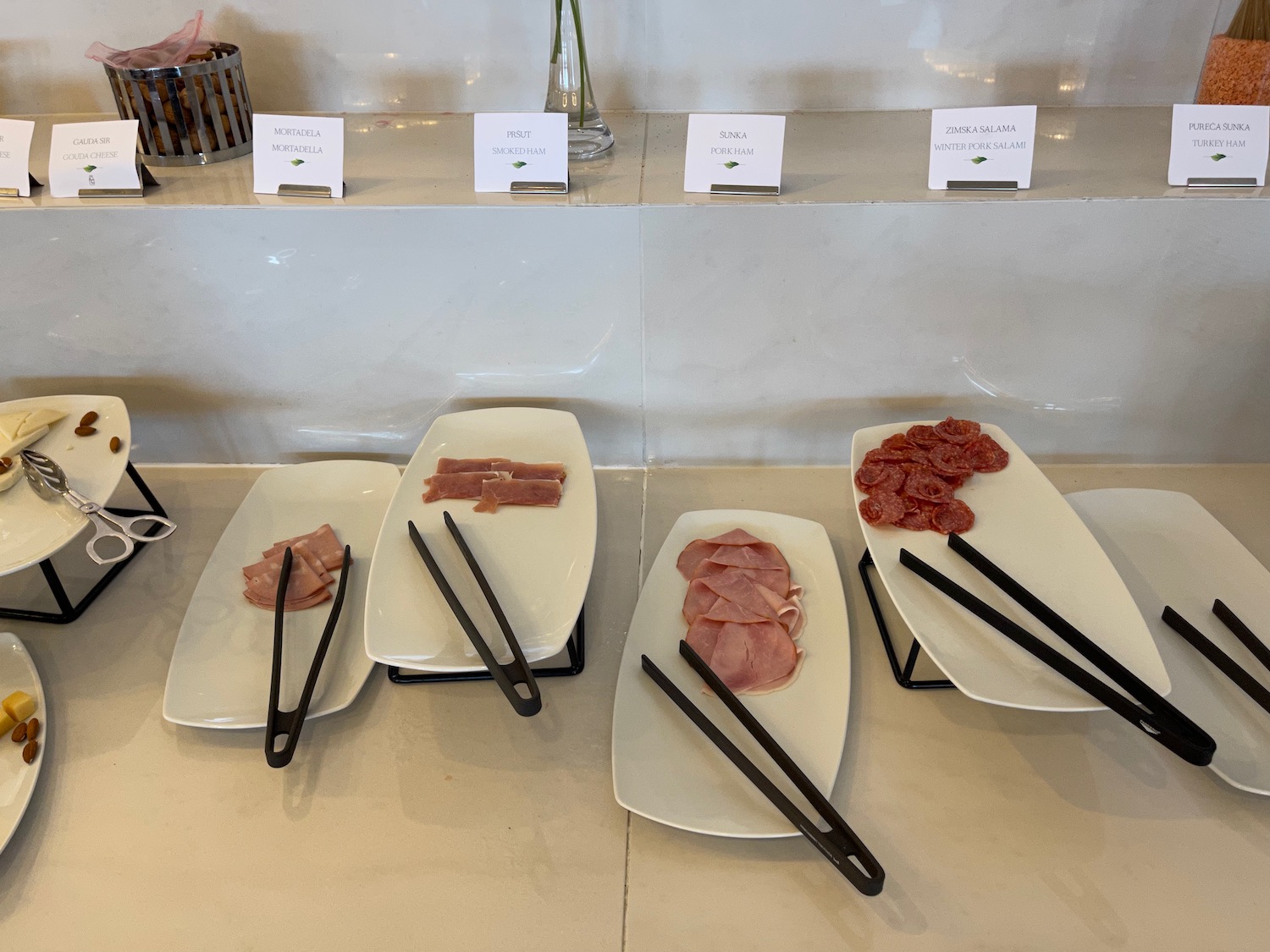 plates of meat and chopsticks on a table