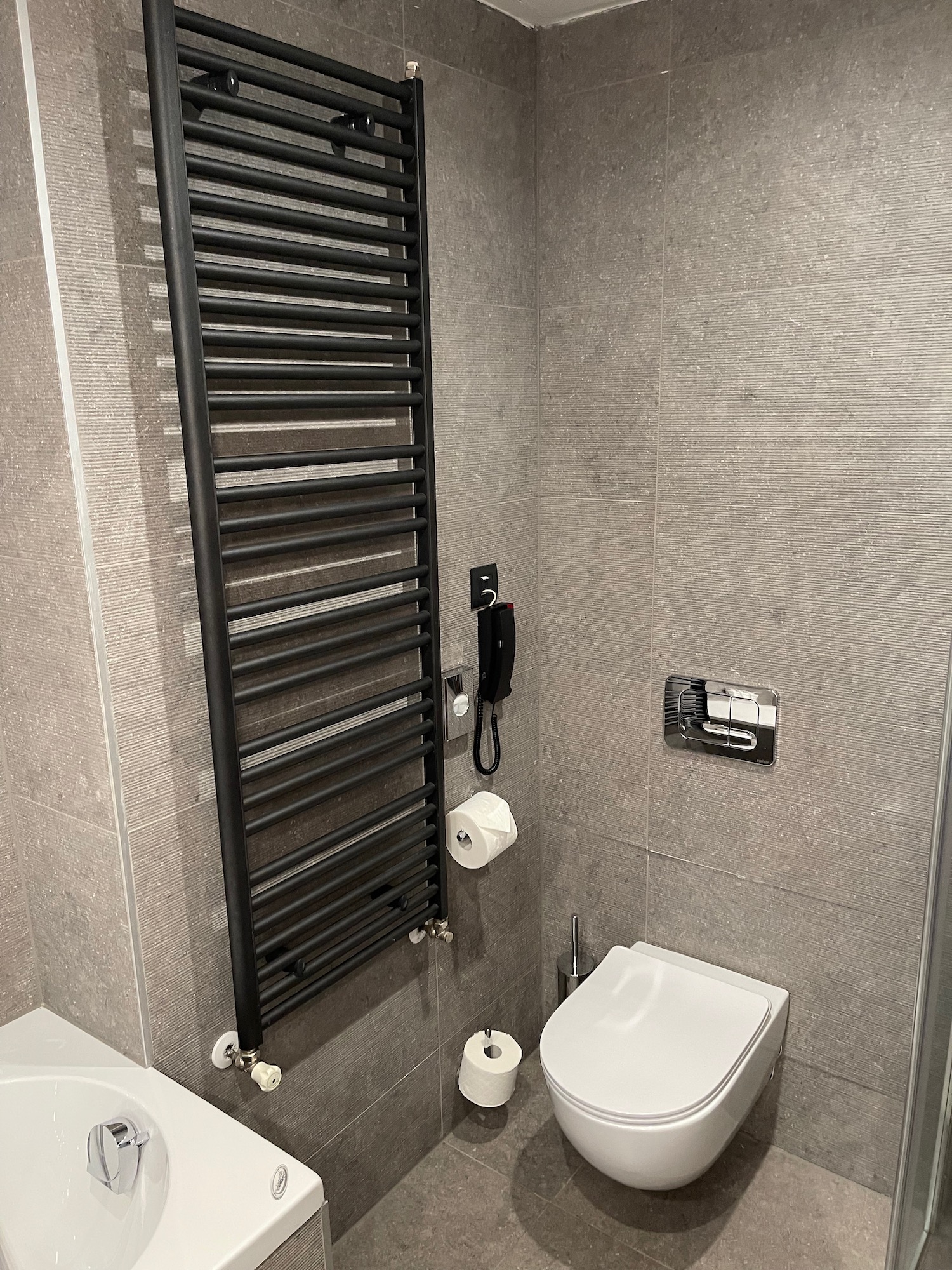 a bathroom with a black towel rack