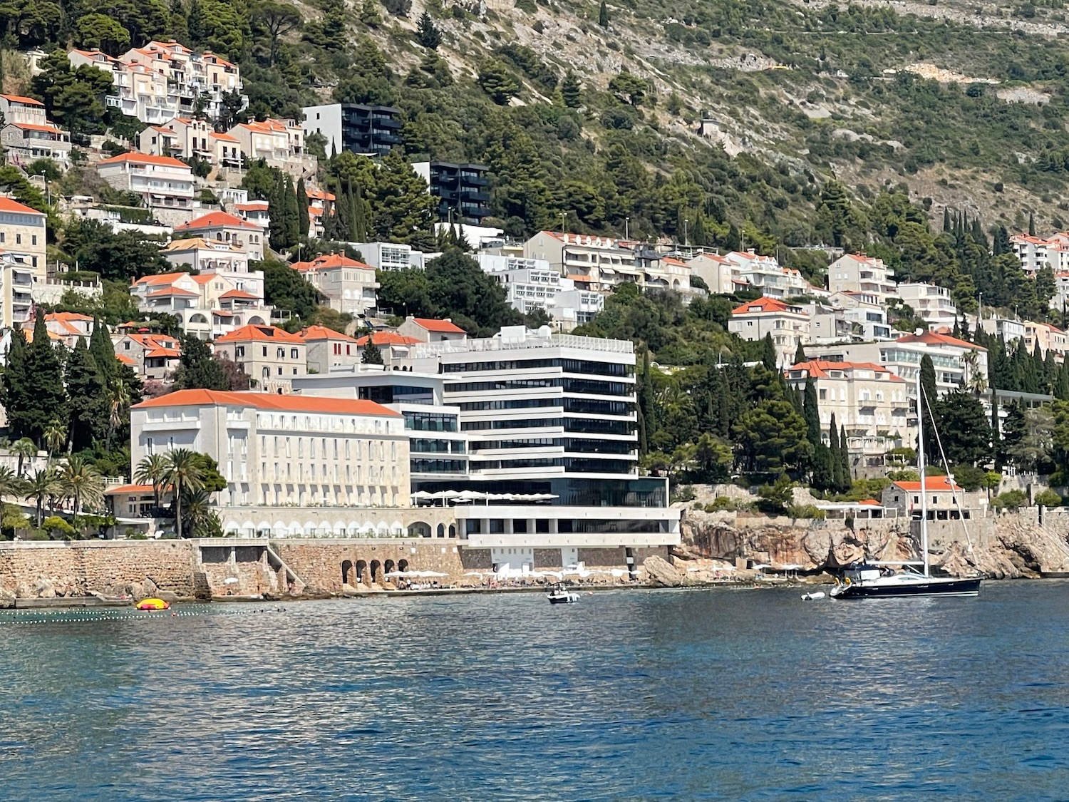 a body of water with buildings and trees