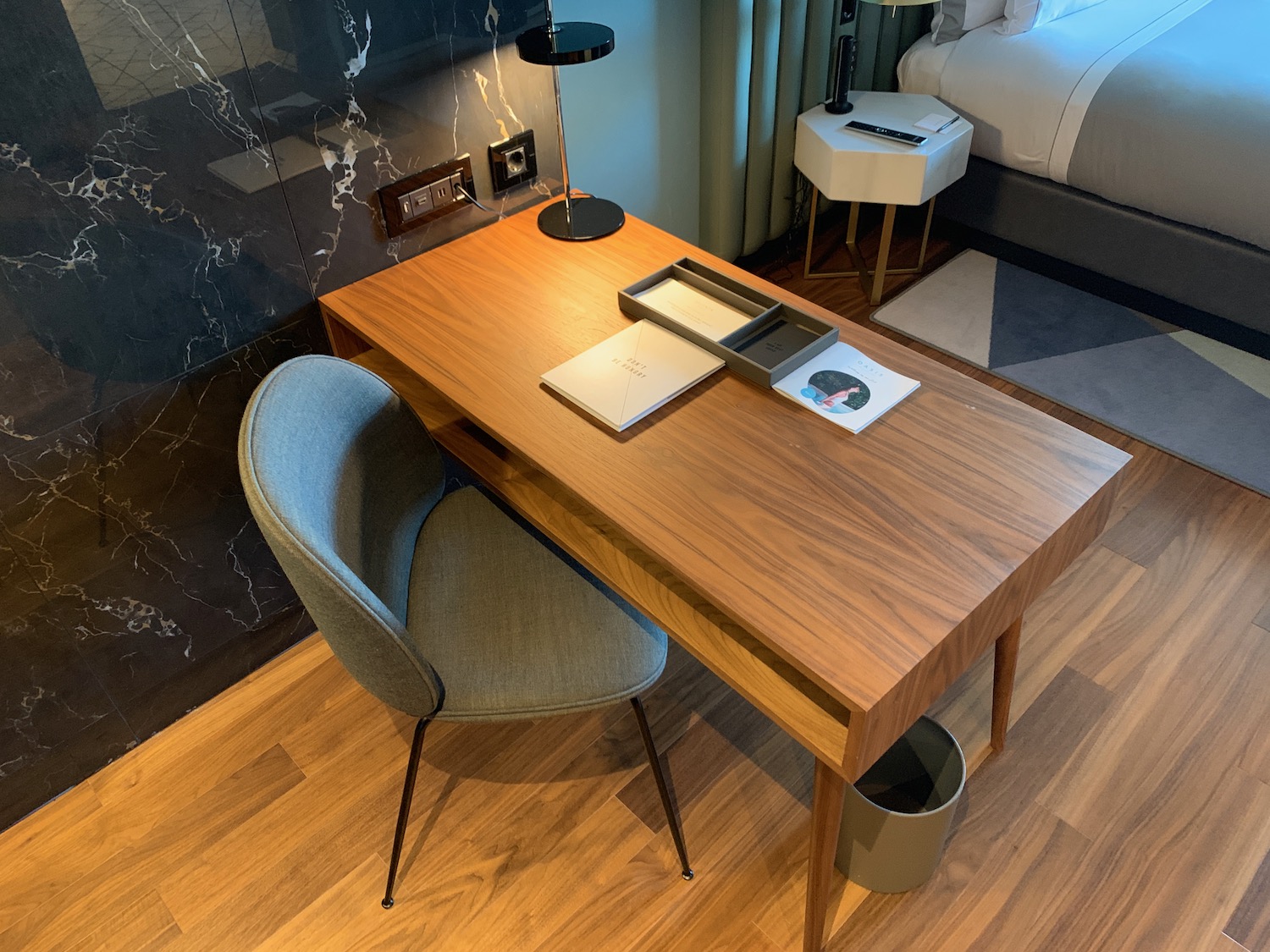 a desk with a chair and a lamp