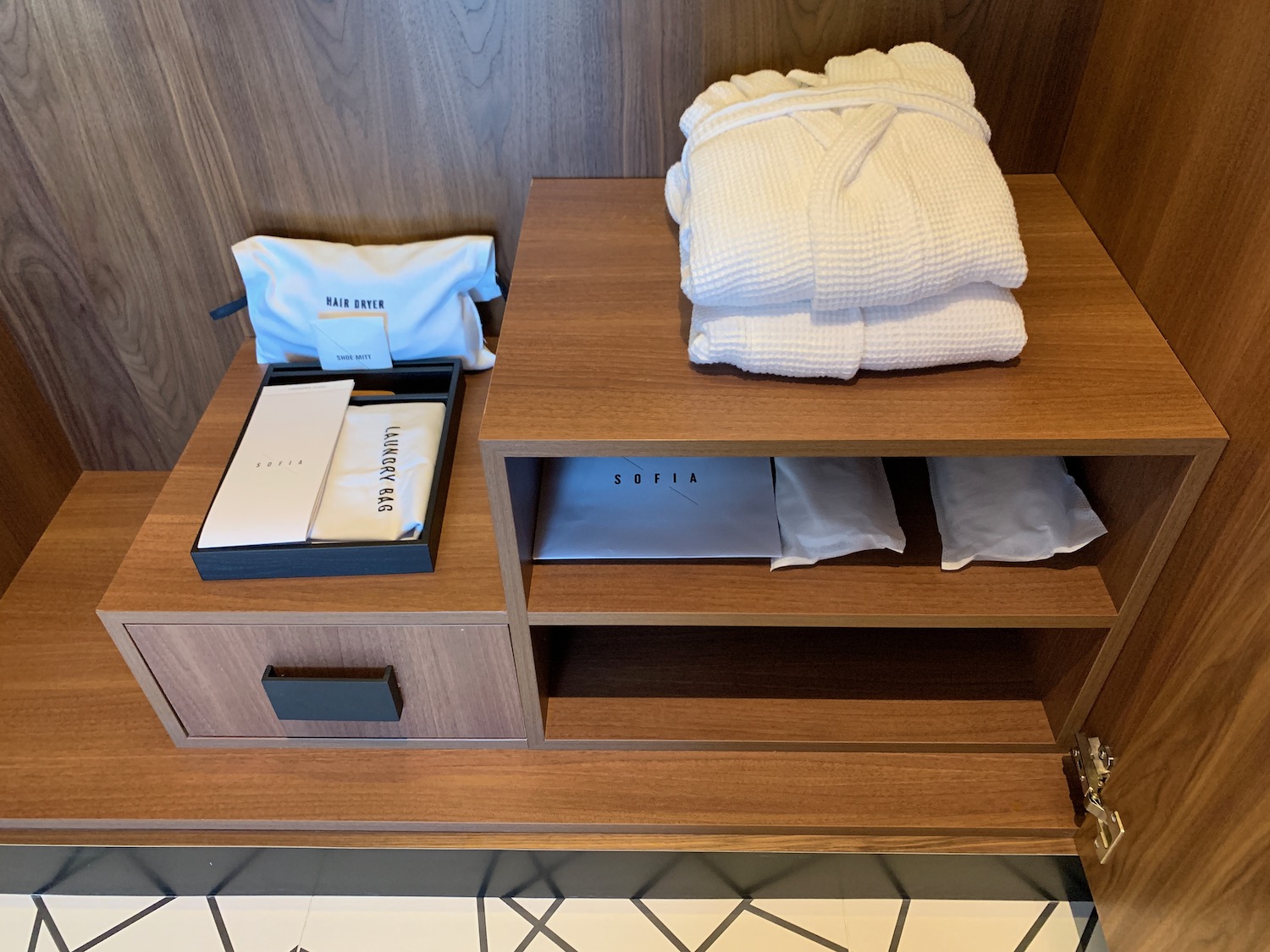 a shelf with a white robe and a box on it