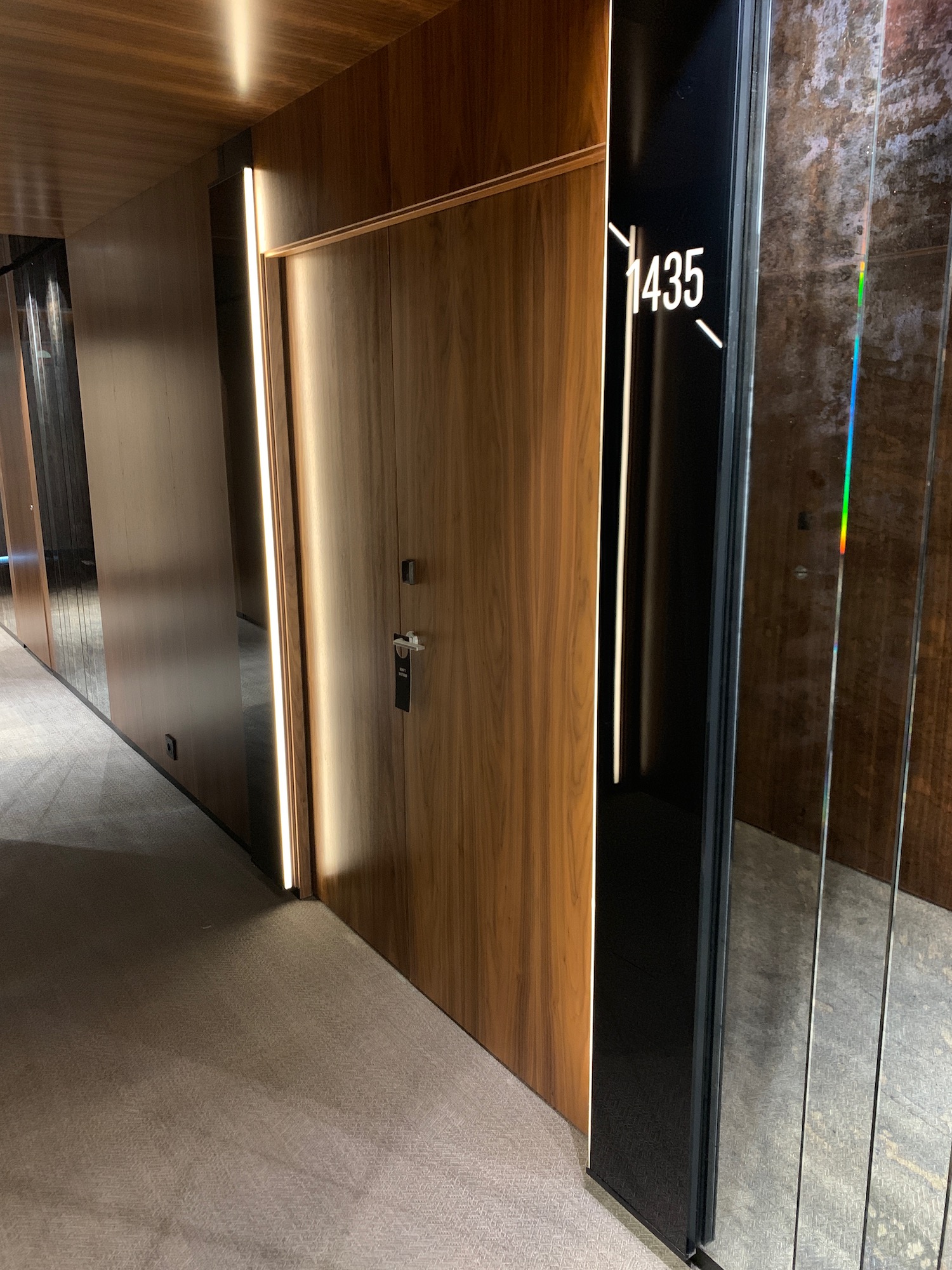 a hallway with a door and glass walls