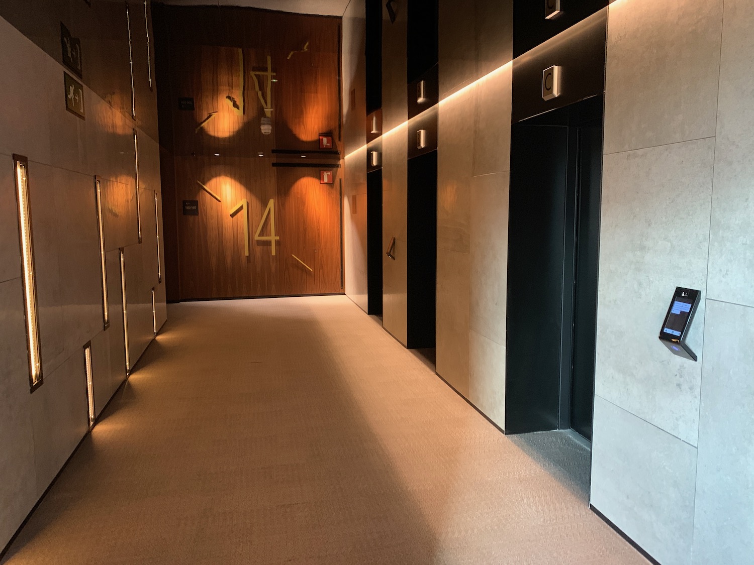a hallway with elevator doors and lights