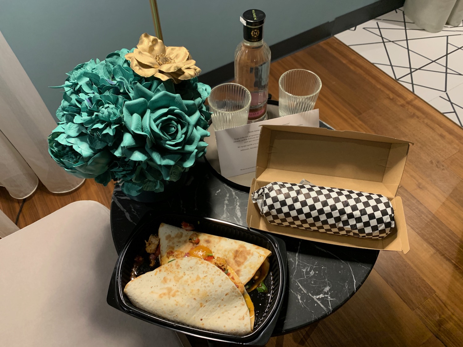 a burrito and a flower on a table