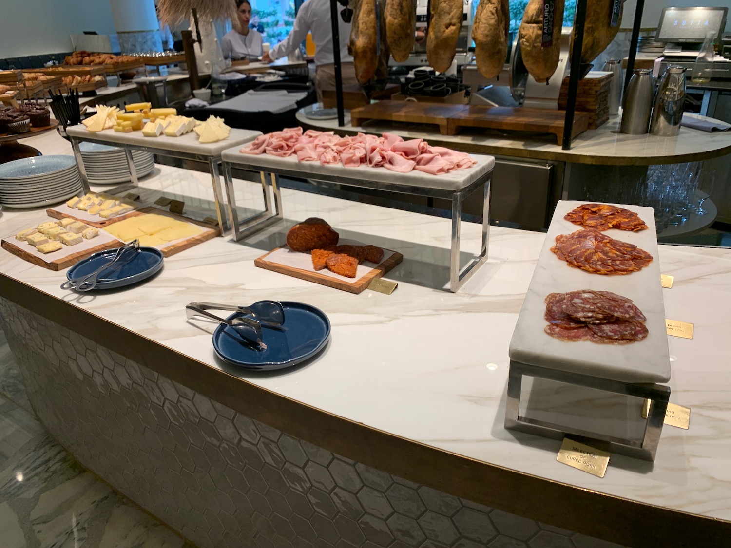 a buffet table with different types of meats and cheeses