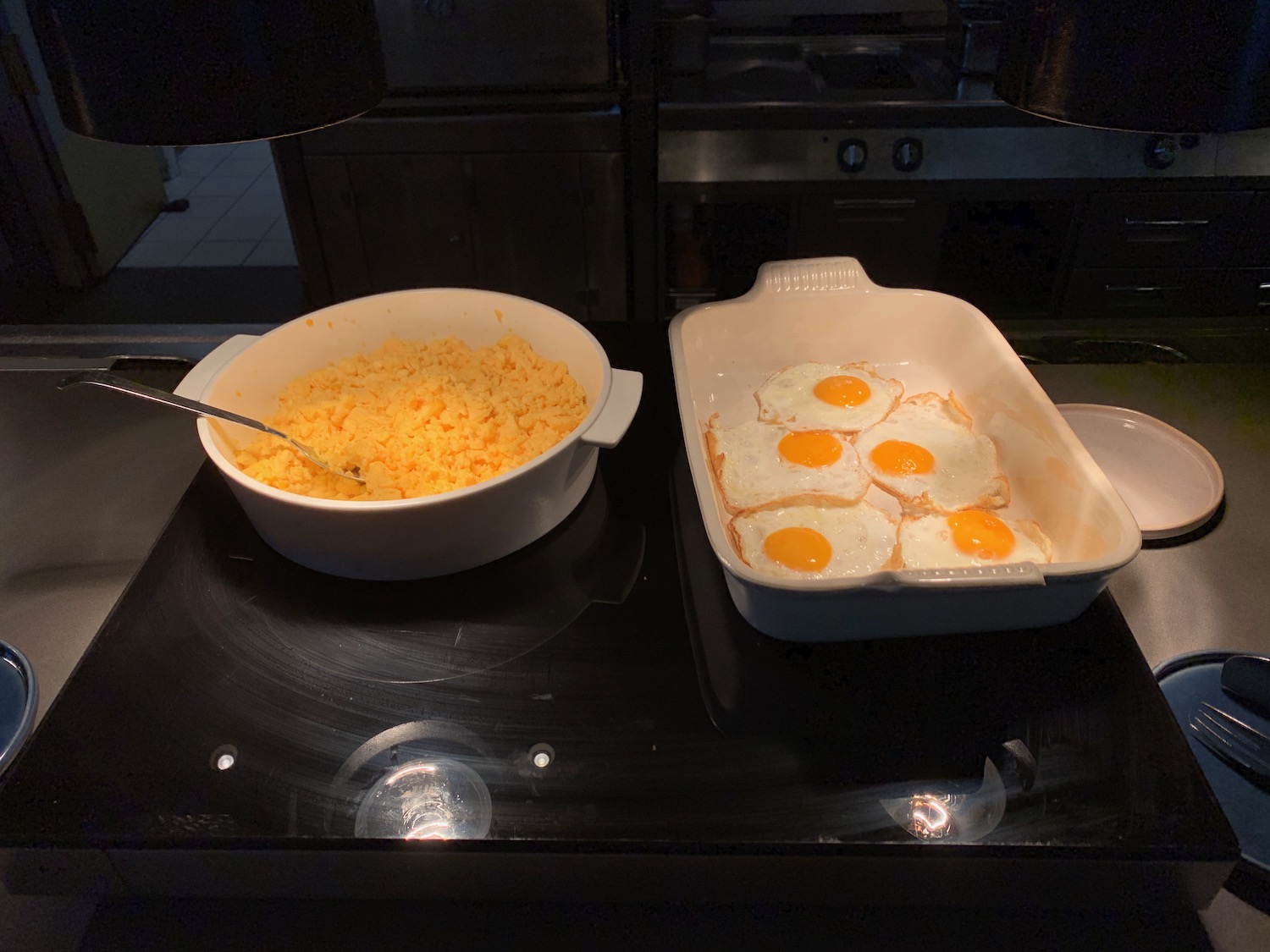 a bowl of eggs and a bowl of cheese on a stove