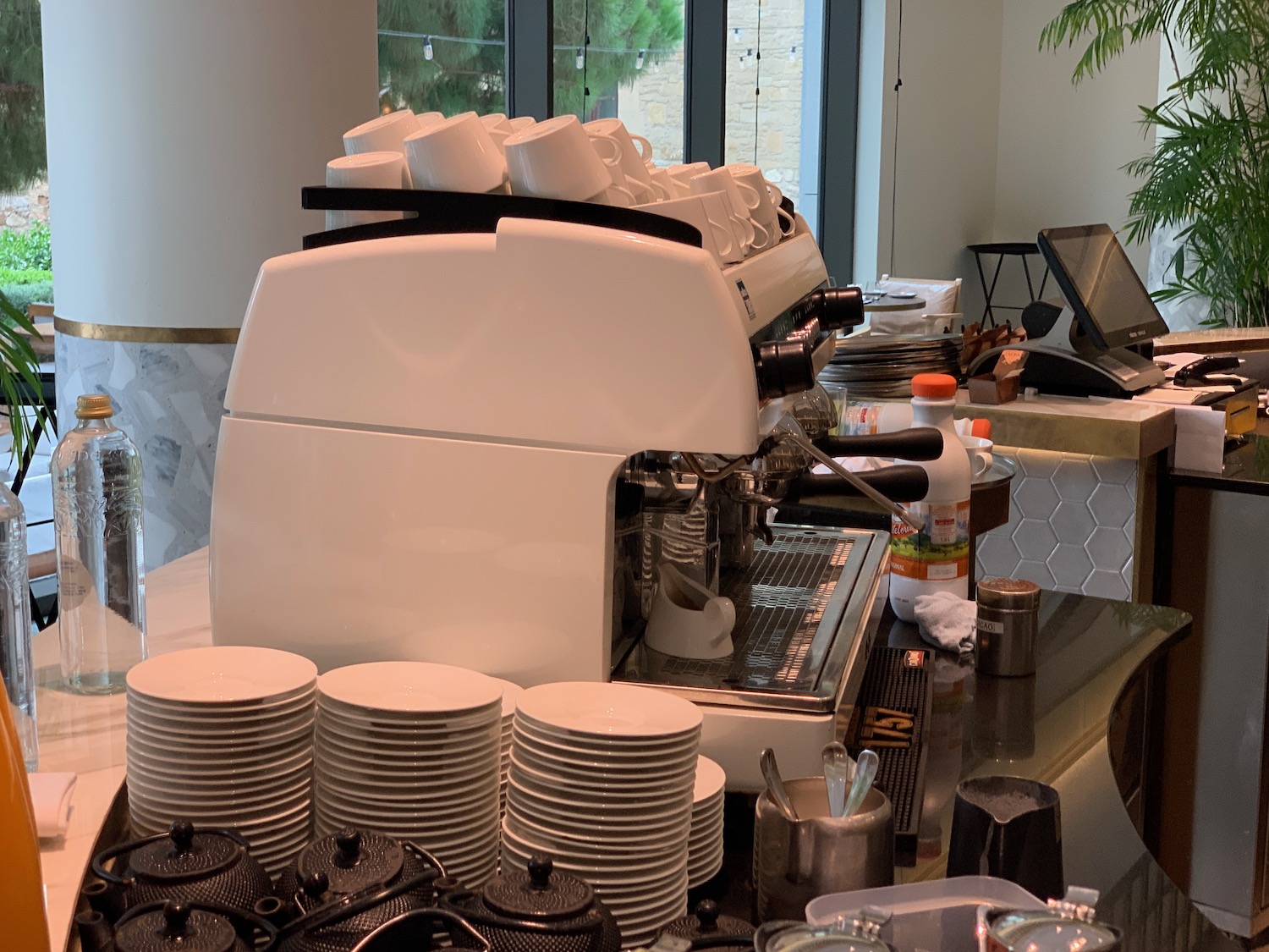a coffee machine with a stack of plates