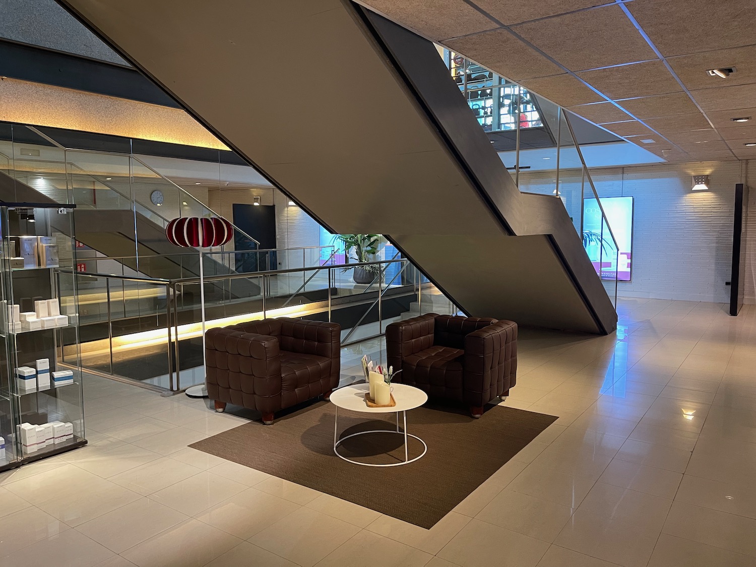 a staircase with a set of chairs and a coffee table