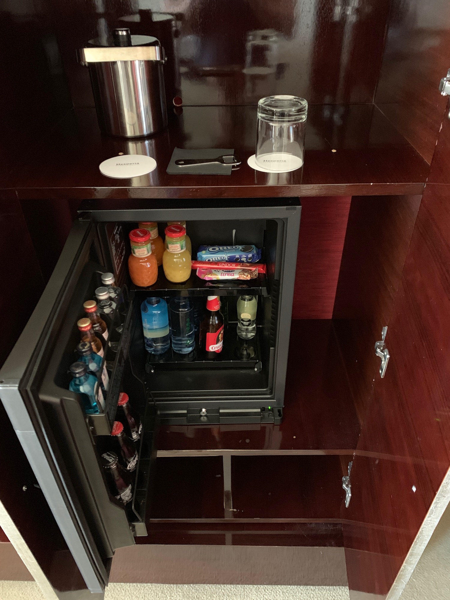 a small refrigerator with drinks and snacks inside
