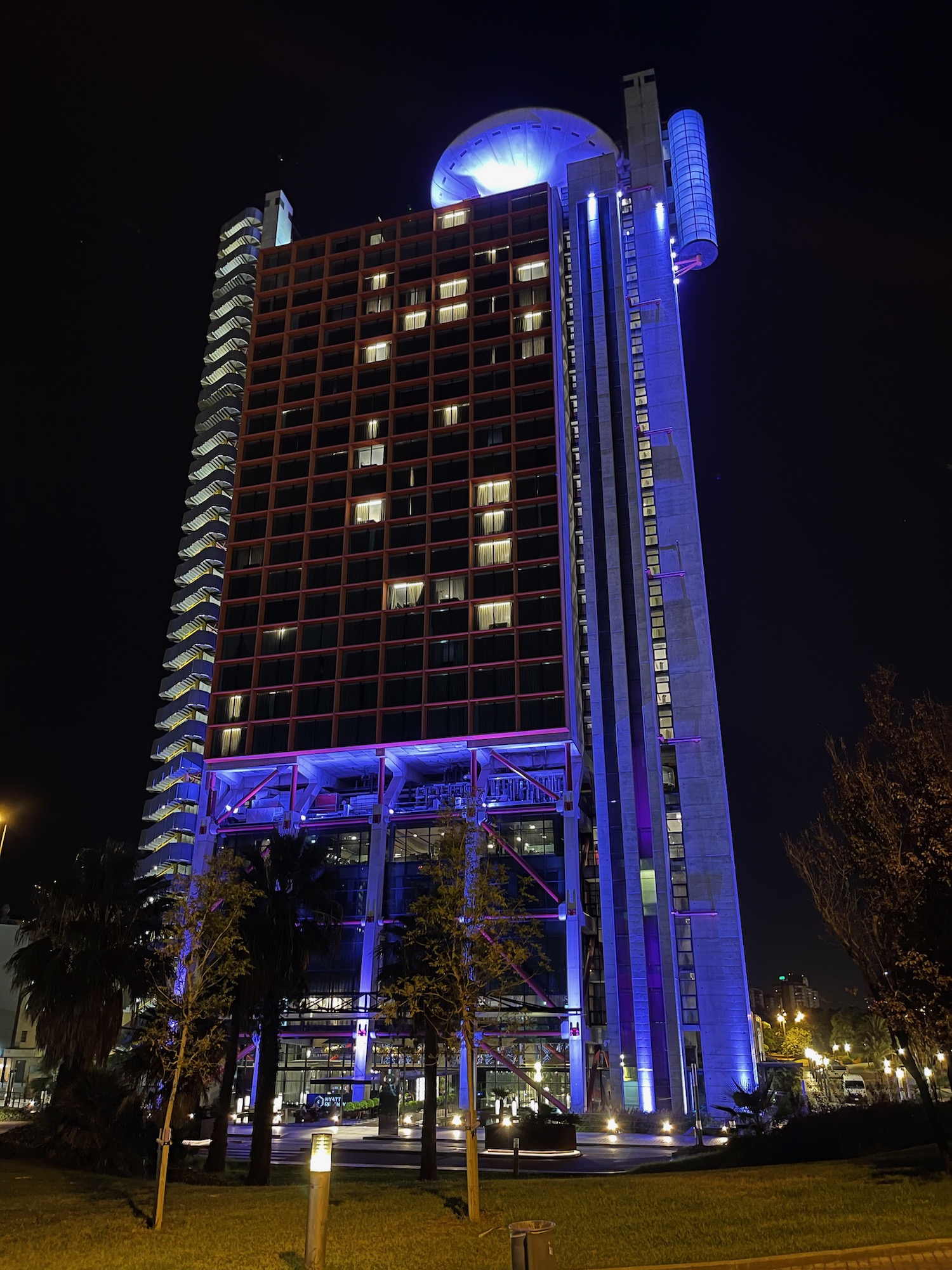 a tall building with purple lights