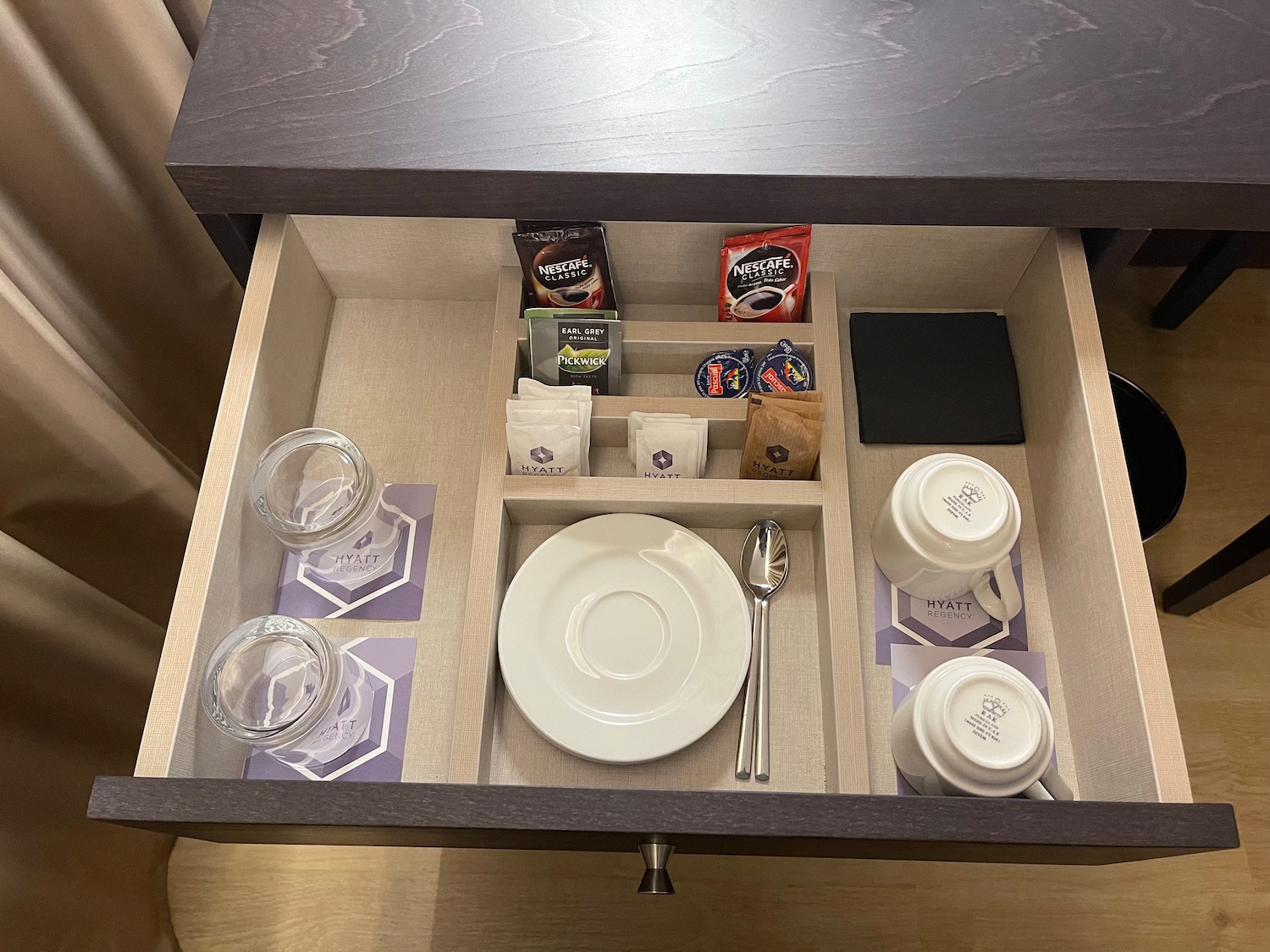 a drawer with a plate and teacups